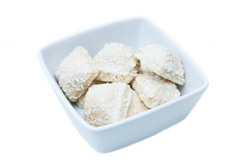 Fototapeta na wymiar Cakes with coconut on a square bowl on white background