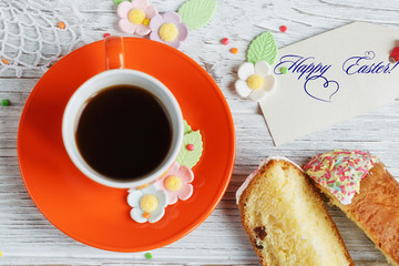 Table setting for Easter - Easter cakes, coffee cup and colored