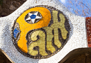 Fototapeta premium Sign of The Park Guell close-up on February 13, 2015 in Barcelona, Spain. Park Guell is the famous park was designed by Antoni Gaudi and built in the years 1900 to 1914.