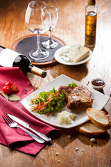 gourmet dinner with grilled beef fillet on wooden table