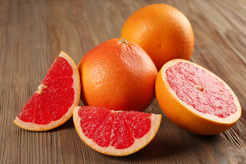 Juicy grapefruits on wooden background