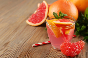 Ripe grapefruits and fresh juice with mint, close up