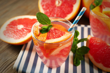 Ripe grapefruits and fresh juice with mint, close up