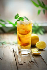 Glass of iced tea with lemon on a windowsill