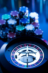 casino theme, high contrast image of casino roulette, playing chips and dice