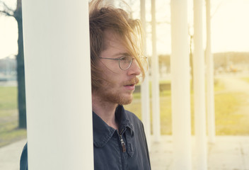 portrait of young man with long red hair