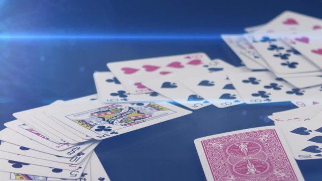 poker cards falling on the table in slow motion