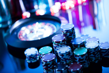 casino theme, high contrast image of casino roulette, playing chips and dice