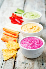 multicolored vegetables beans hummus with vegetables and chips