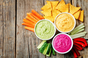 multicolored vegetables beans hummus with vegetables and chips