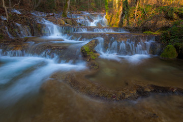 Fototapeta na wymiar Beautiful waterfalls and mountain stream in Transylvania, in early spring