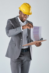Professional engineering consultant with hardhat looking at spre