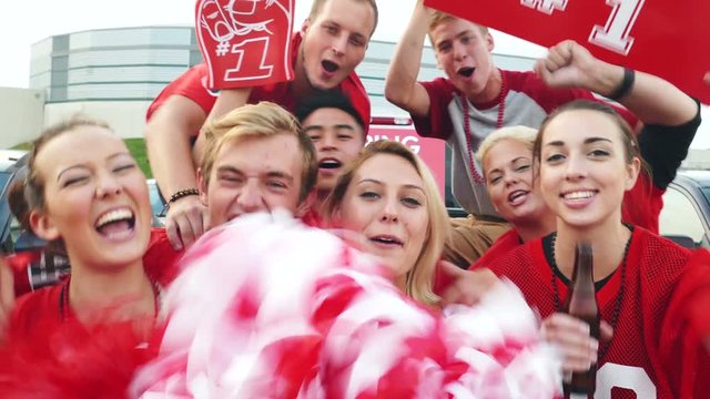 Tailgate: Excited Group Of Fans Led By Woman With Poms