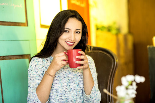 Young woman with a cup of coffee in the morning