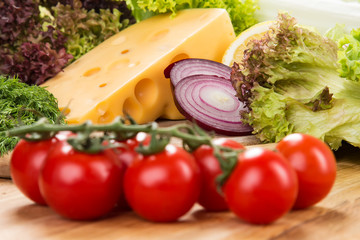 yellow cheese with fresh vegetables