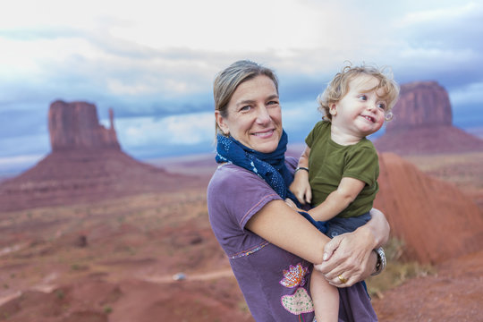 Caucasian mother holding baby son in desert, Monument Valley, Utah, United States