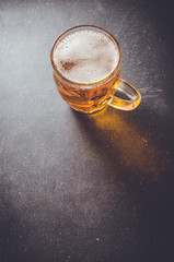 Beer glass on dark table. Close up