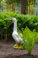 Garden figure of goose and lilies of the valley