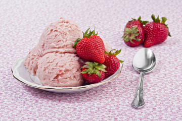 plate of strawberry ice cream served with spoon
