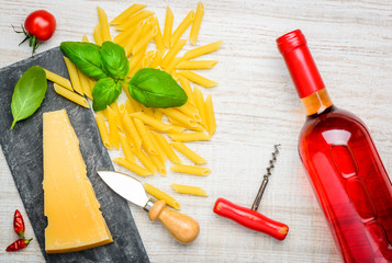Fototapeta na wymiar Parmesan Cheese, Penne Pasta and Rose Wine
