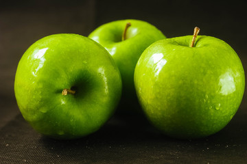 fresh green apple on black background