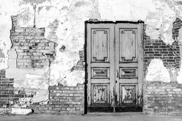 Monochrome front viewed photo of old textured wall and door