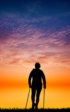 Nordic walking silhouette at sunset