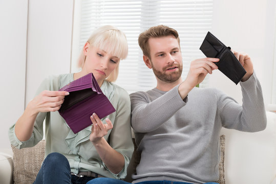 Couple Looking At Empty Wallet