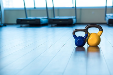 exercise weights - iron dumbbell with extra plates on a wooden d