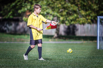 Young soccer referee on the field