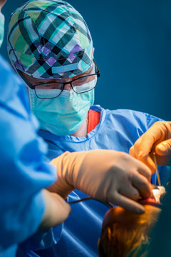 Orthopedic surgeon trying to fix a knee joint.