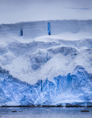 antarctic iceberg with blue reflection
