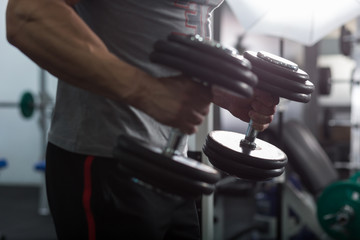 Closeup of a muscular young man lifting weights, Caucasian man