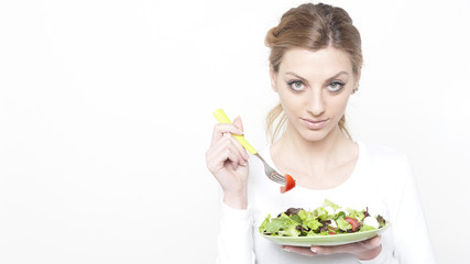 Young blonde woman with plate of salad 