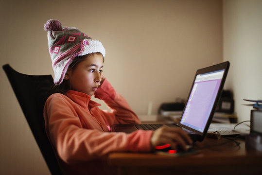 Mixed Race Girl Using Laptop At Desk