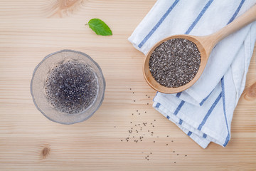 Nutritious chia seeds in glass bowl with wooden spoon for diet f