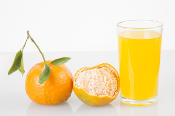 Tangerines and juice glass isolated on white background