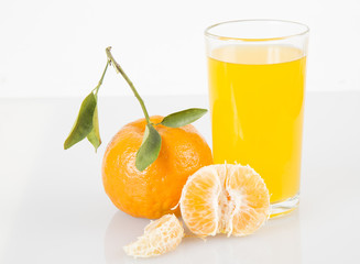 Tangerines and juice glass isolated on white background