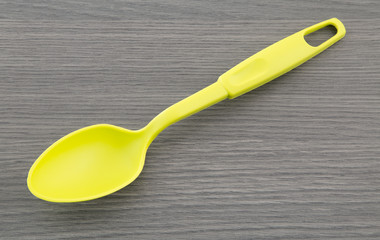 Plastic spoon on wooden table