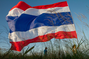 Unidentified Tourism raise the Thailand flag on the mountain
