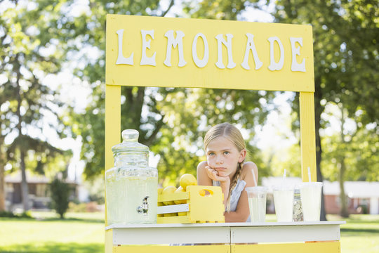 Bored Caucasian girl at lemonade stand
