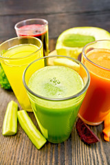 Juice cucumber and vegetable in glassful on board