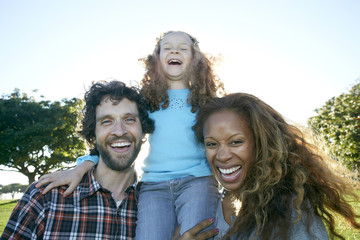 Family laughing together outdoors