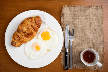 breakfast biscuit croissant egg coffee