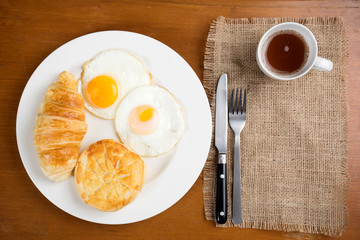 breakfast biscuit croissant egg coffee