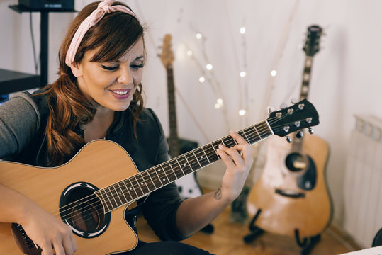 Woman Recording Guitars and at his Home Sound Studio.