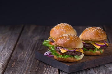 Three juicy beef burgers