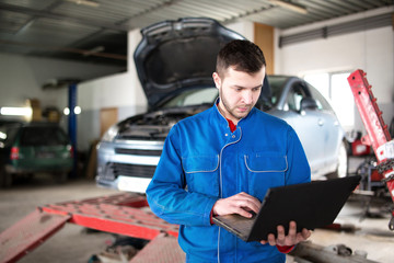 View of a Young attractive mechanic working at the garage.  - 106846045