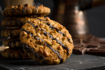 Glass of coffee with cookies on wooden background