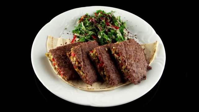 Grilled minced meat stuffed with cheese, pistachios and sweet bell pepper on the pita bread, loop